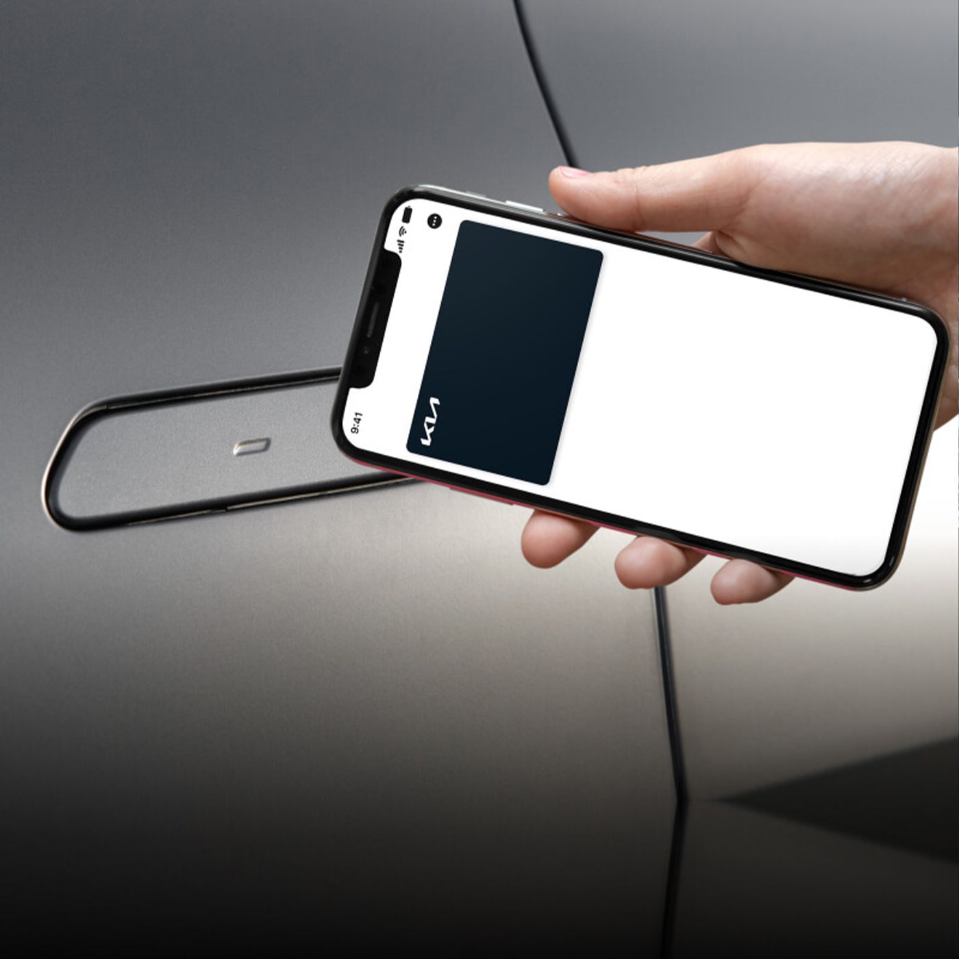 A hand holding a phone with a screen that displays a Kia digital keycard, holding it by the vehicle door