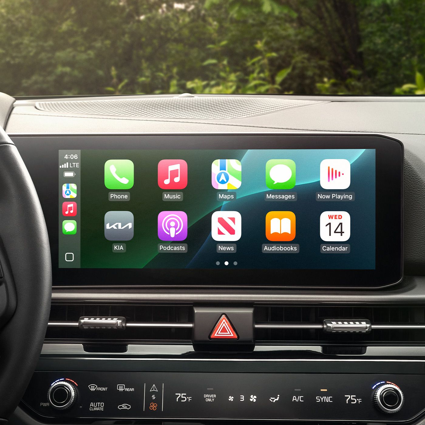 2027 Kia Sportage Hybrid interior, zoomed-in view of the infotainment screen with Apple CarPlay turned on, featuring popular apps like music, podcasts, maps, and messages on the screen.