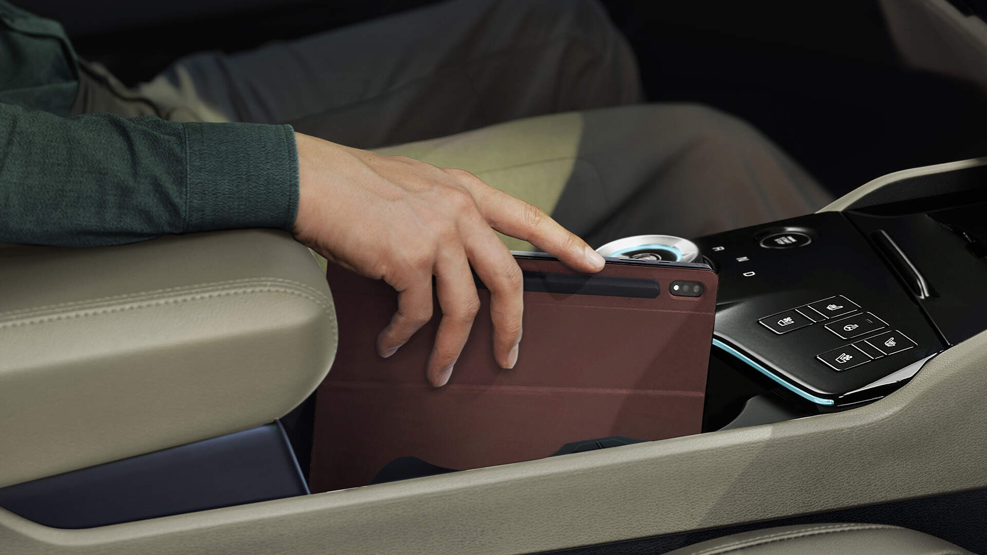 Hand of a man putting the tablet into the centre console