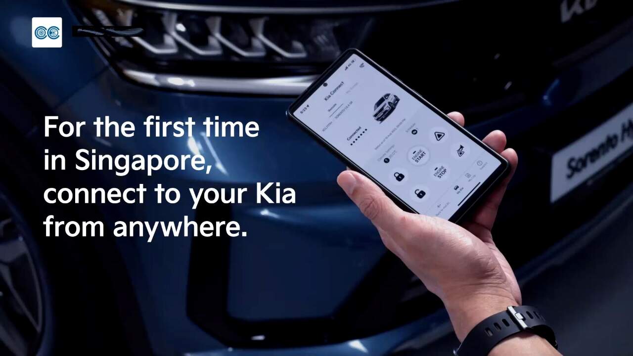 Hand of a man holding mobile phone with the Kia Connect app on