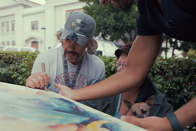 A Homeless Man Signs His Portrait Painted By Brian Peterson