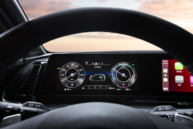 2024 Kia Sportage Plug-in Hybrid zoomed in view of the digital dashboard featuring the driver's power mode, speedometer, and battery gauge