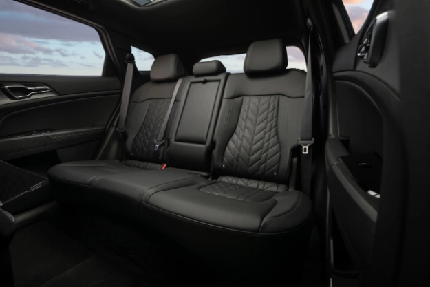 2024 Kia Sportage Plug-in Hybrid interior, second row view, featuring black leather seats with quilted details in the mid section