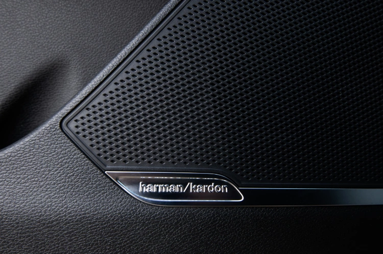 2024 Kia Sportage Plug-in Hybrid interior, close-up view of the Harmon sound speaker on the lower section of the door