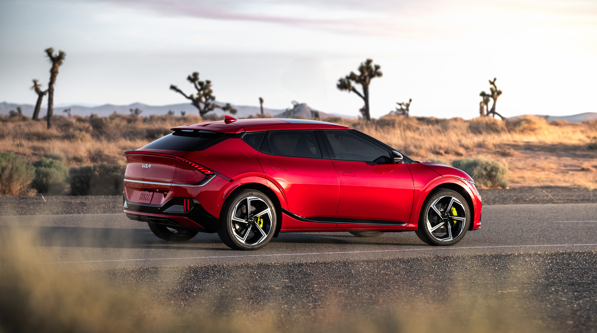 2023 Kia EV6 Parked On A Desert Road Rear Three-Quarter View