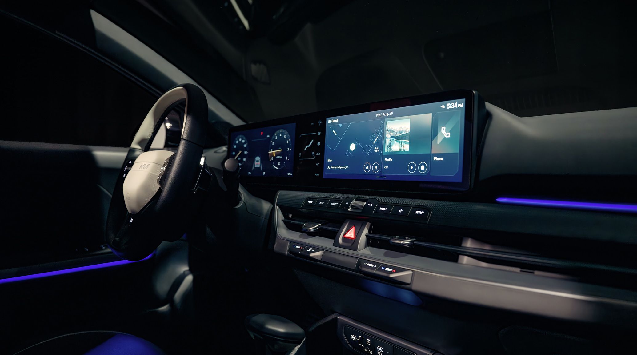 An interior shot of the 2026 K4 Hatchback GT-Line Turbo showing the customizable digital display featuring Map, Music, Phone and ambient lighting.