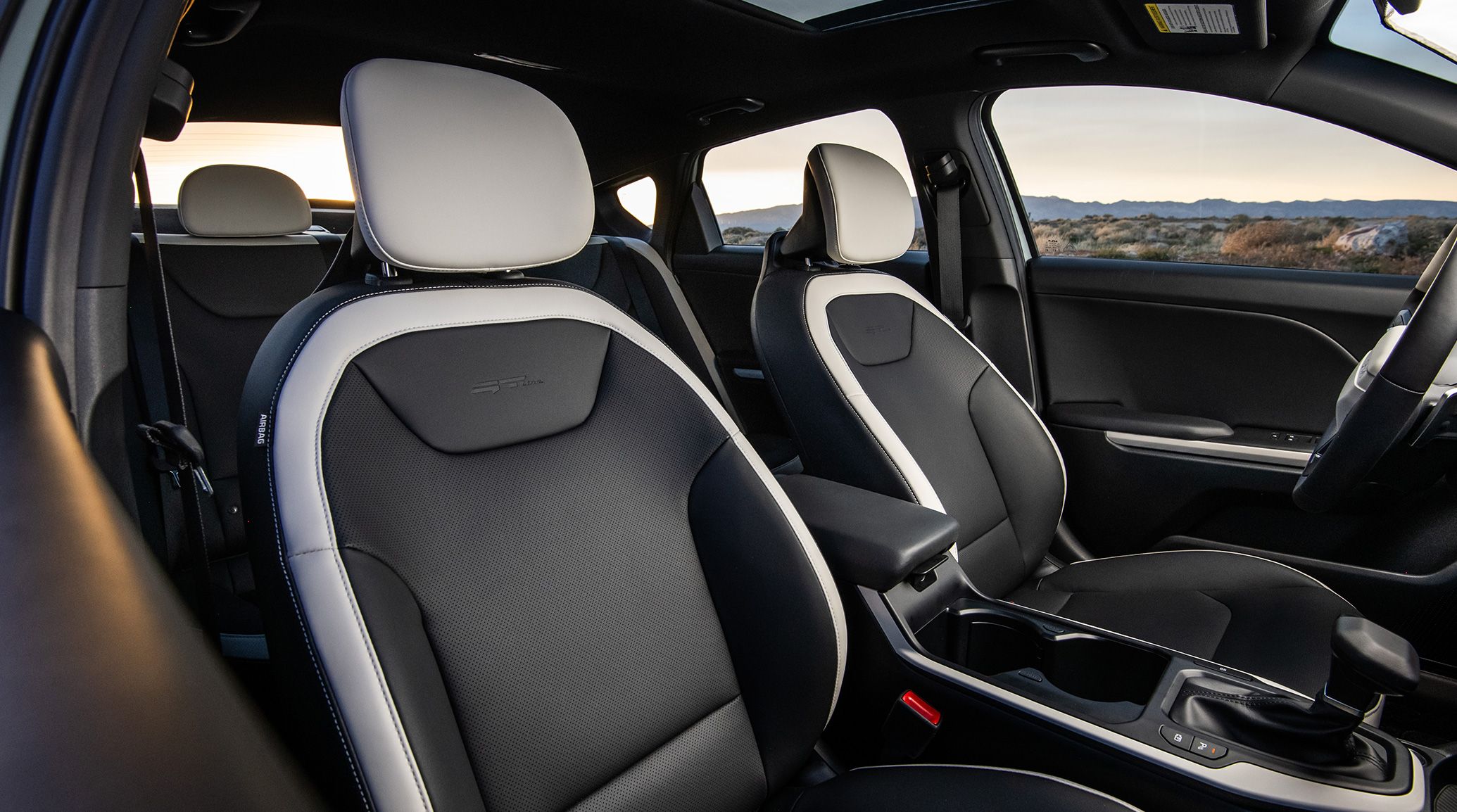 2025 Kia K4's spacious first row and comfortable seats, side-view