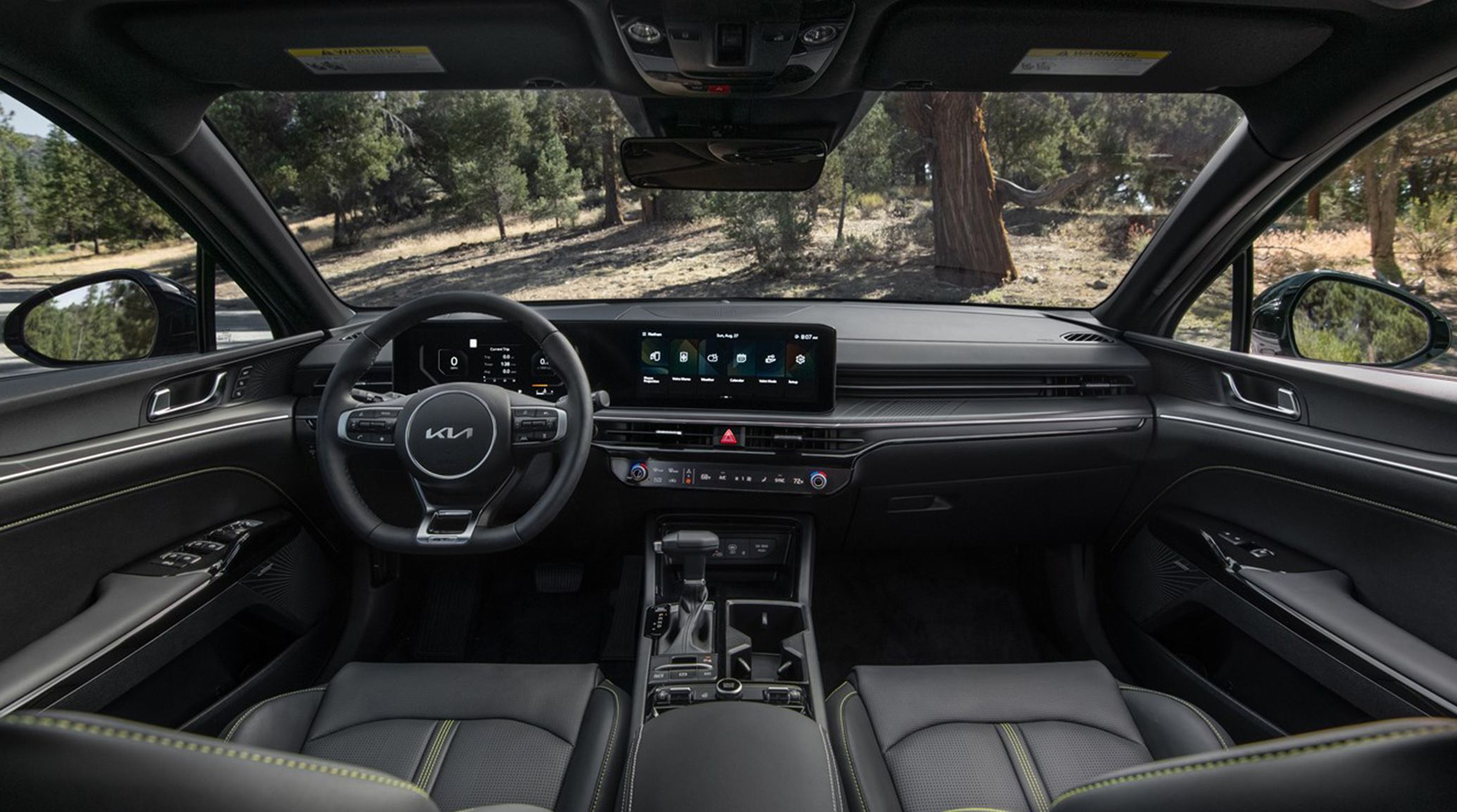 Kia K5 EX trim cockpit view of the leather yellow thread stitched interior and panoramic view navigation screen