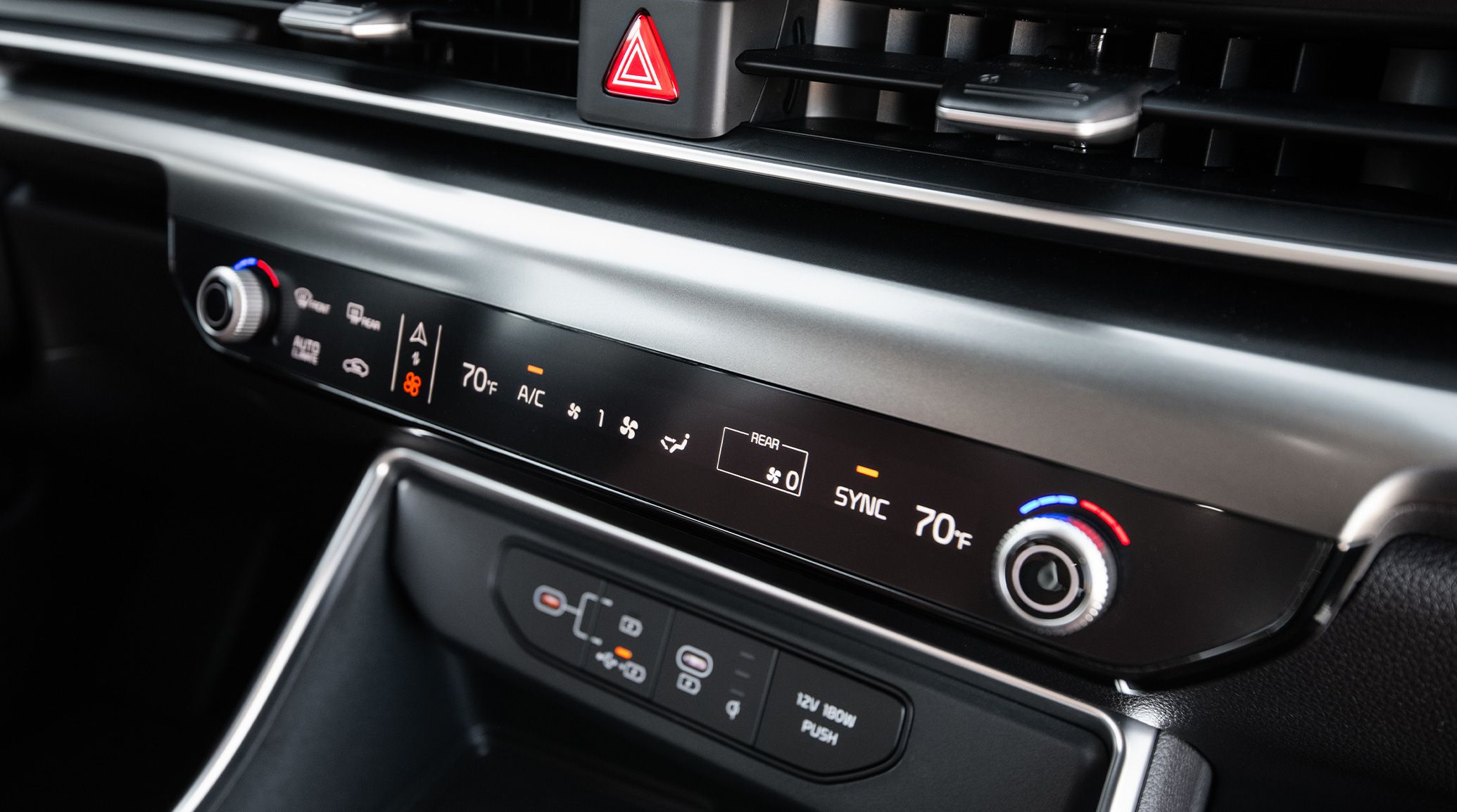 An interior shot of the 2027 Kia Carnival MPV that highlights the intuitive control with HVAC, audio controls, and outlets underneath.