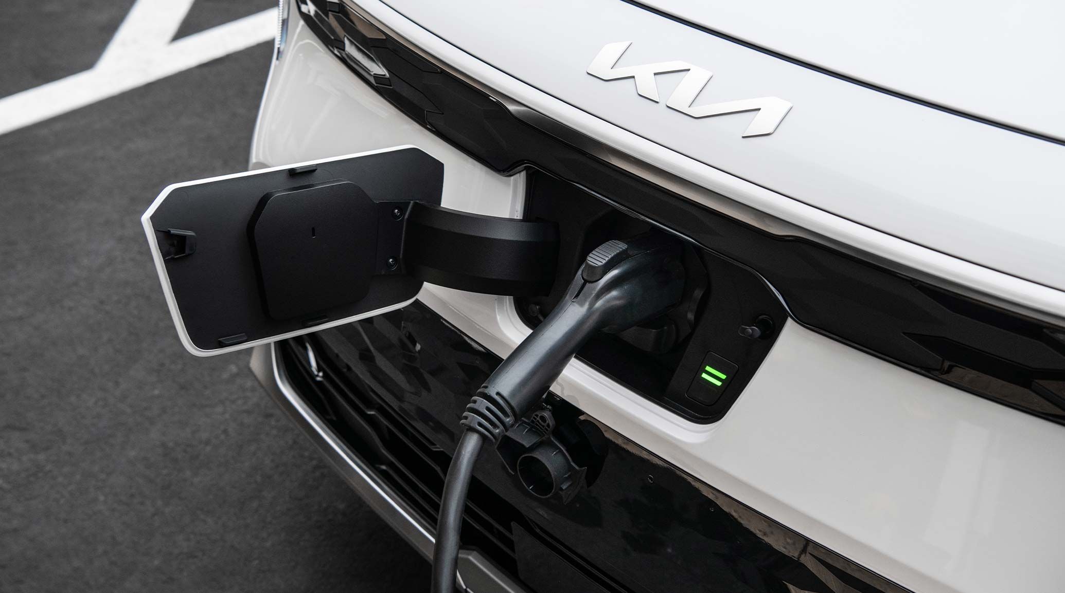 2026 Kia Niro EV being charged at a public station, close-up