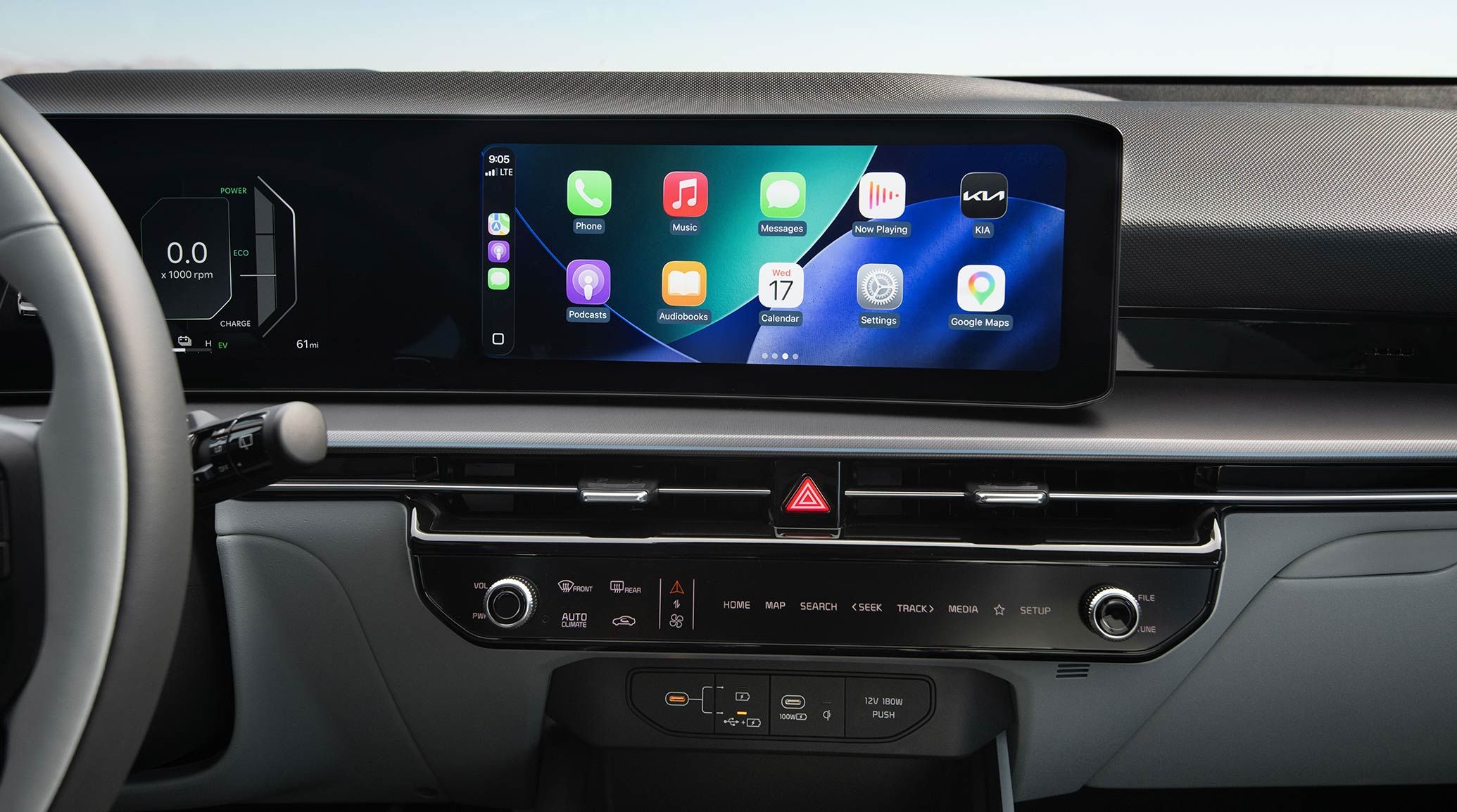 A close-up view of the Kia interior showing the digital display screen, currently featuring popular apps such as Phone, Music, Maps, Messages, Podcasts and more. 