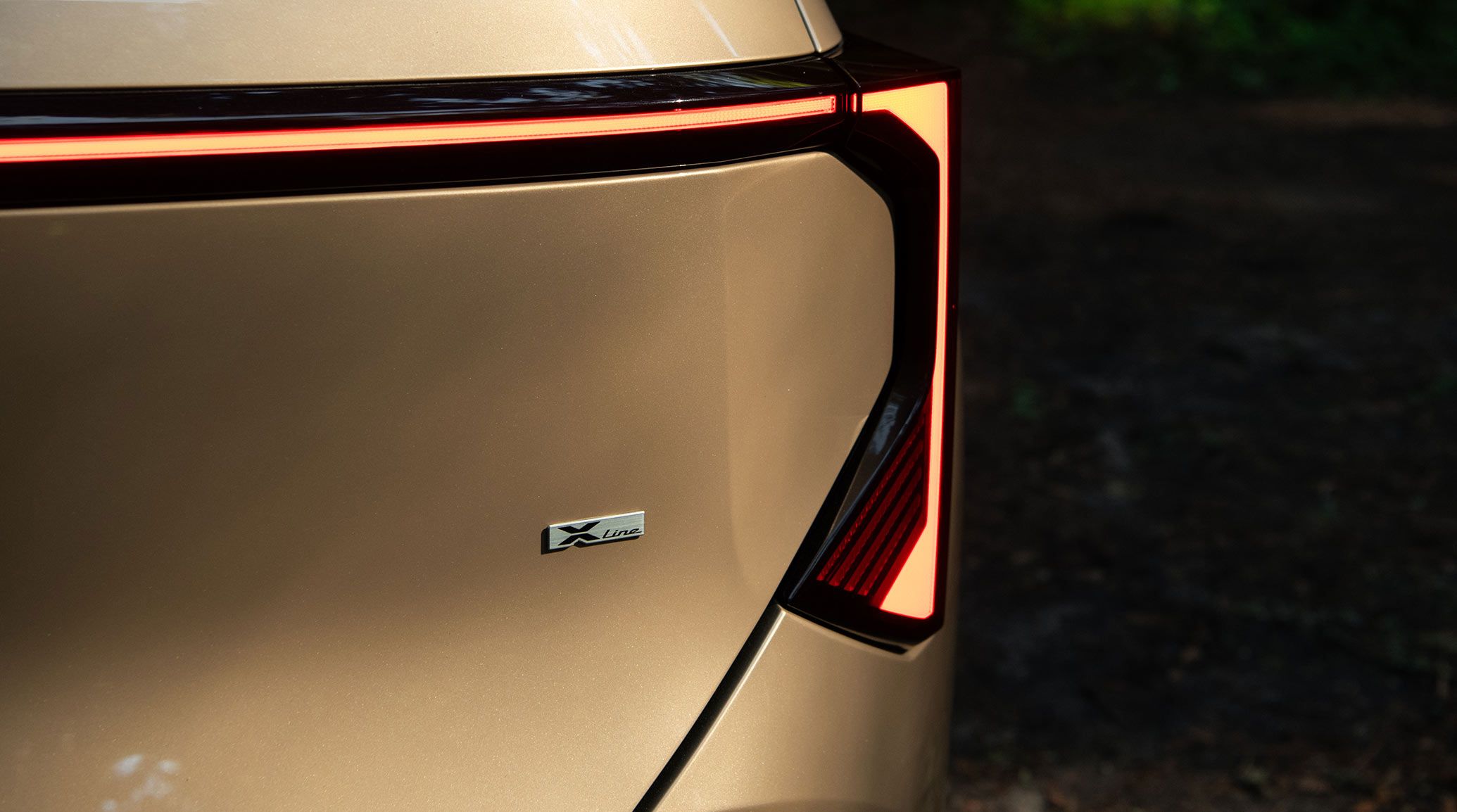 2027 Kia Seltos front three-quarter view parked on a gravel clearing