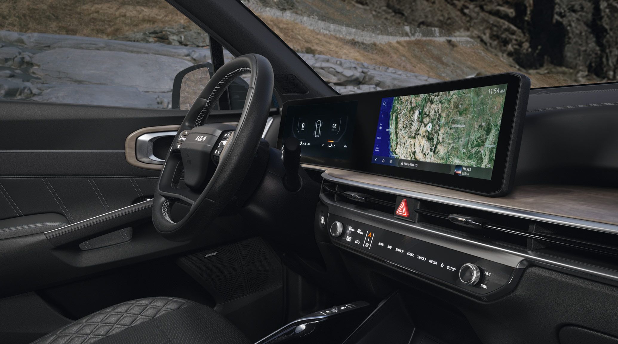 Interior view of the 2027 Kia Sorento Hybrid SUV showcasing its steering wheel, media controls, digital touchscreen display with map and vehicle information visible, and other interior details.