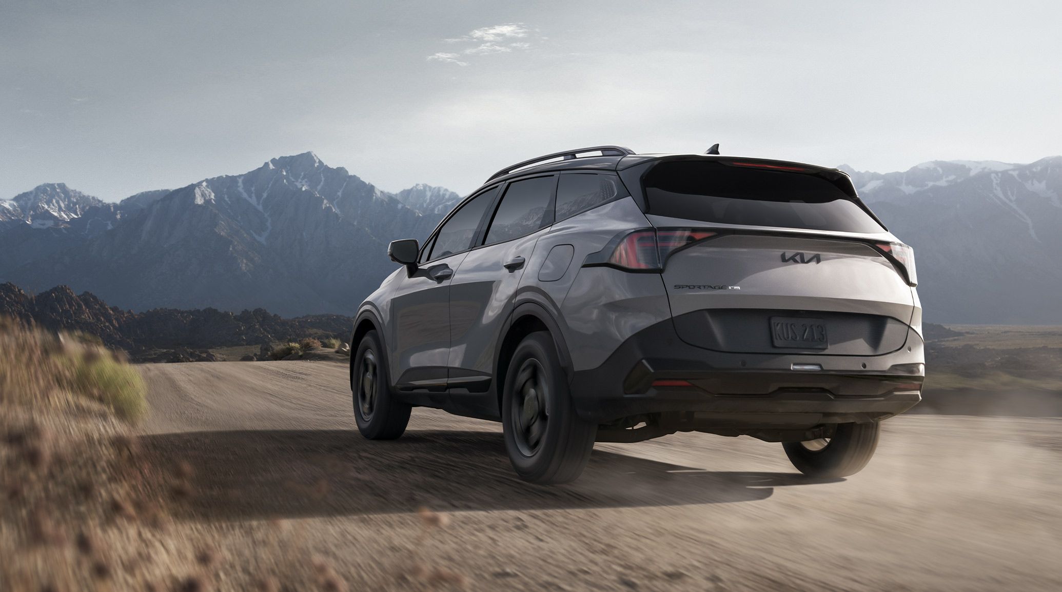 2027 Kia Sportage front three-quarter view on a paved road