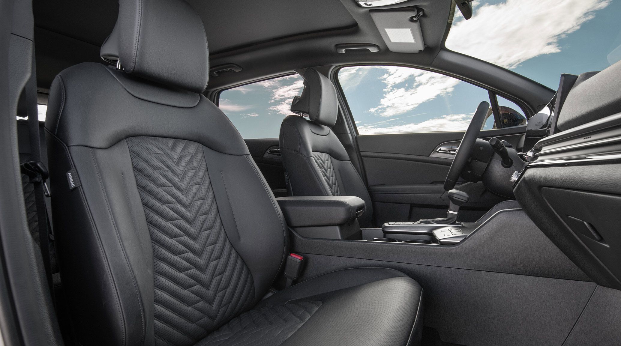2027 Kia Sportage second row, showing rear seat space and the door panel