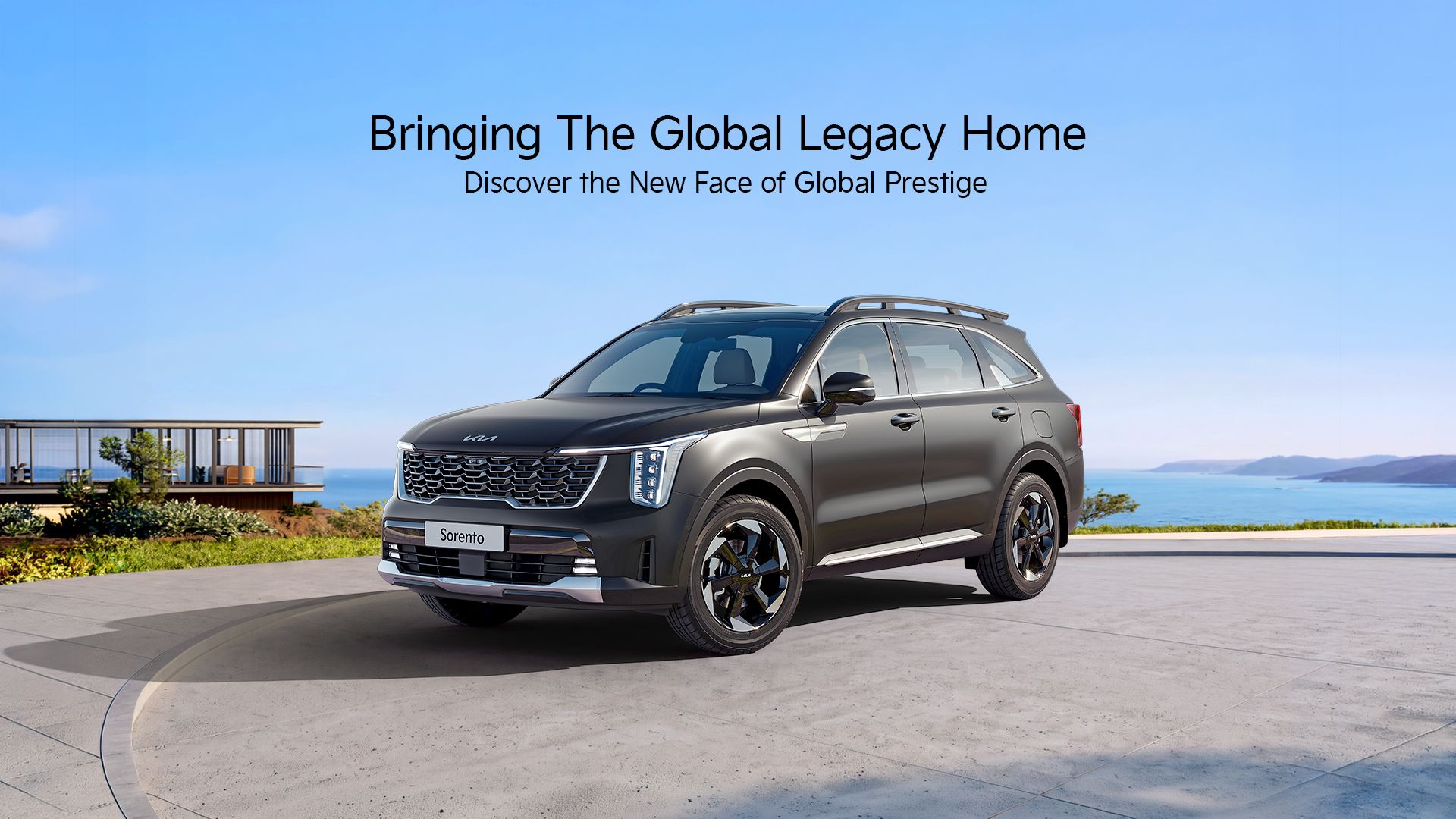 A Kia Sorento in Dark Gun Metal (Matte) shown from the front three-quarter view at a premium waterfront residence.