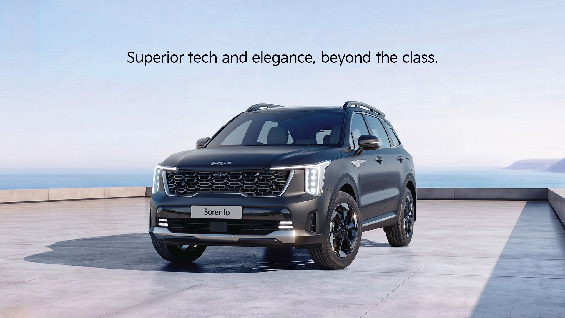 A Kia Sorento in Dark Gun Metal (Matte) shown from the front three-quarter view at a premium waterfront residence.