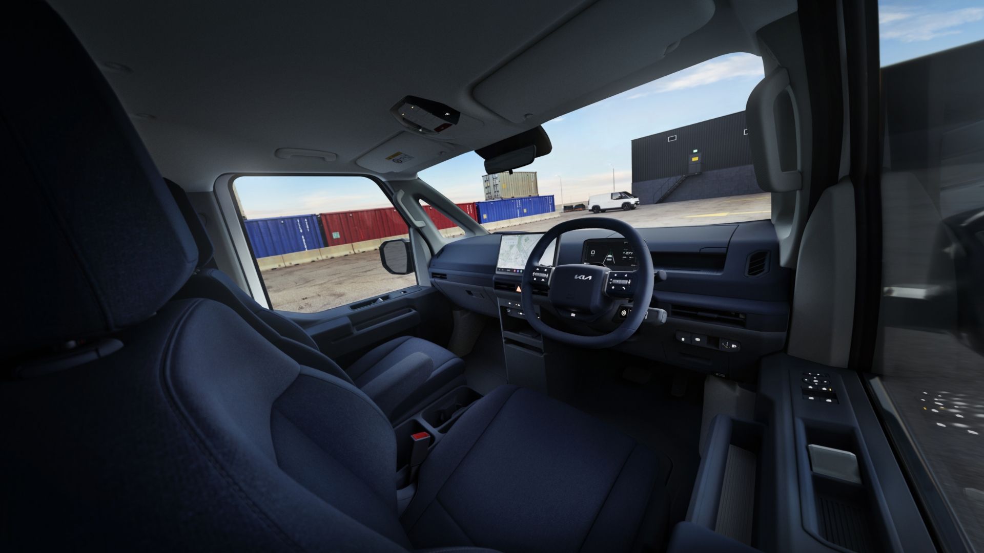 Front driver’s view of Kia PV5 interior showing steering wheel and infotainment display