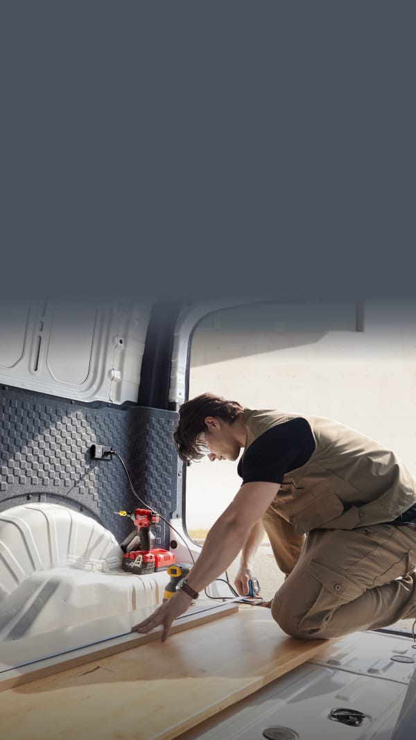 The Kia PV5 Cargo interior shown with tools and equipment for illustrative purposes.