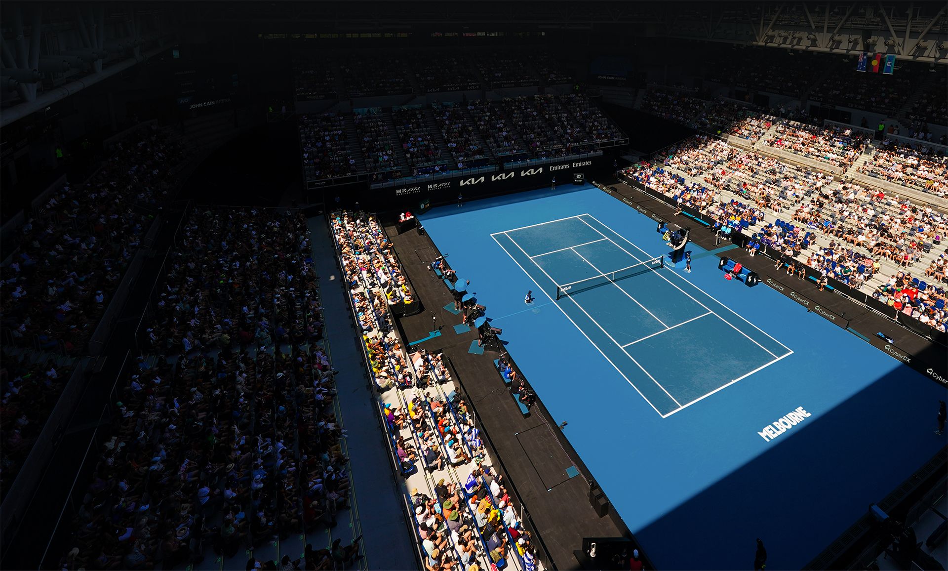 Panoramic view of the Australian Open main court packed with spectators under natural light