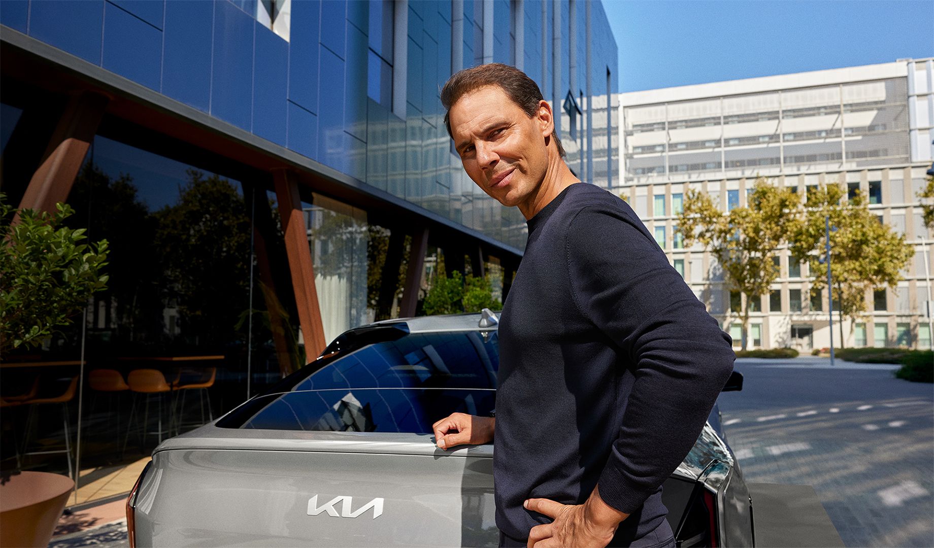 EV4 and Rafael Nadal standing next to the EV4.