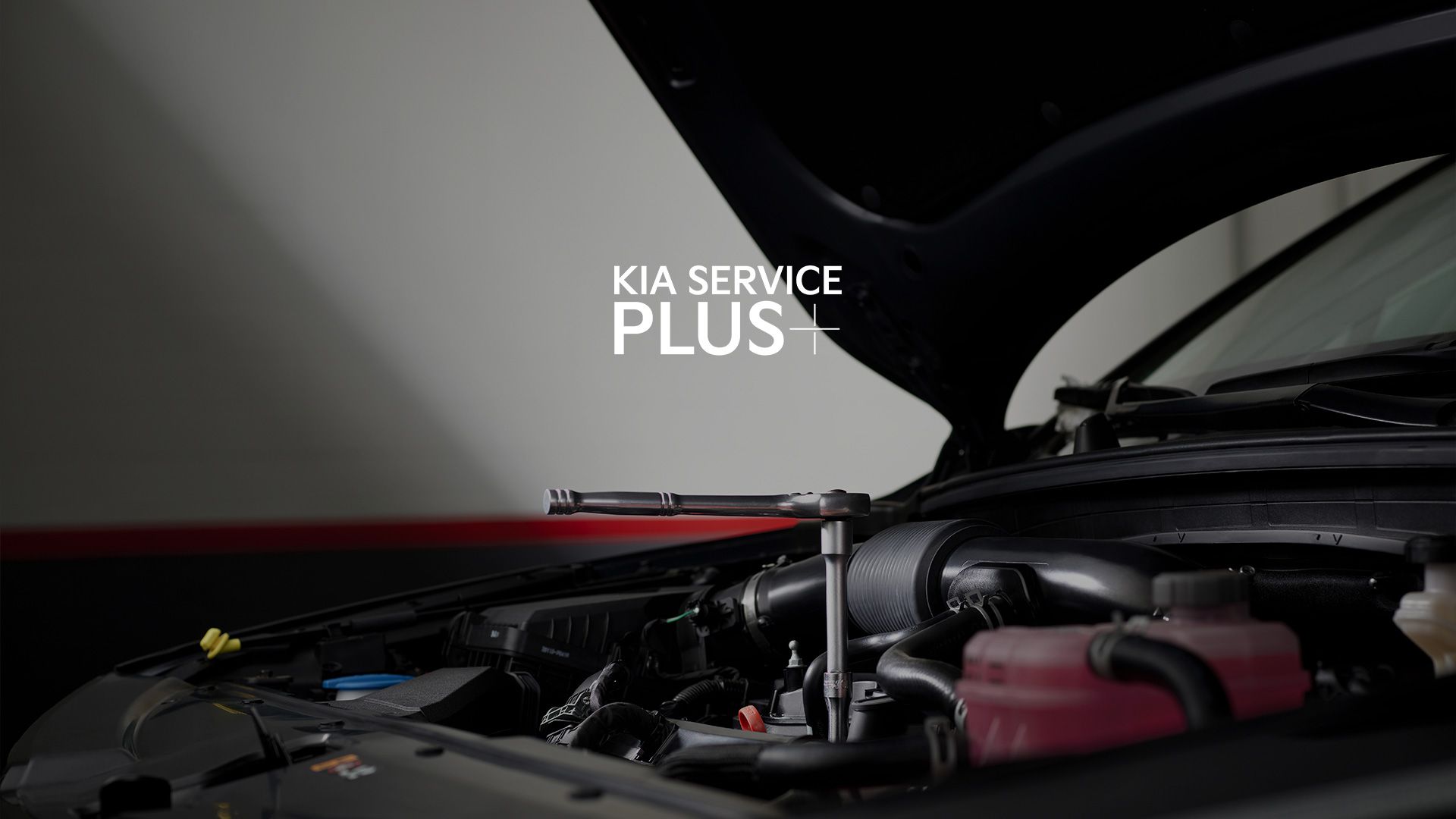 Open hood view of a Kia Sportage with a torque wrench on engine components