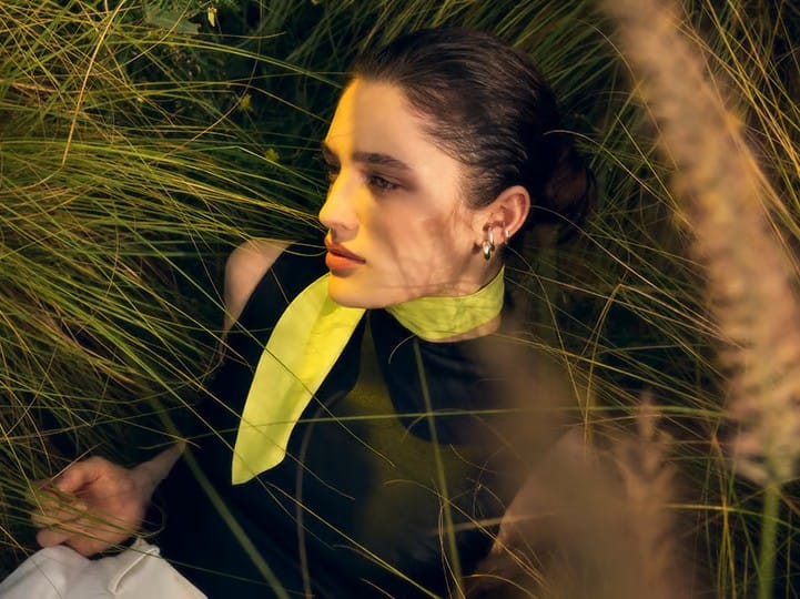 Lachende Frau hält sich die Hand vor das Gesicht