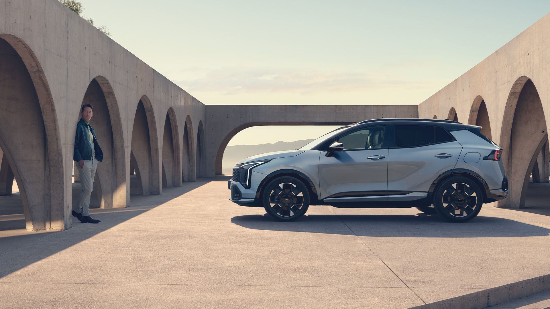 Vue approchée du phare arrière avec une mannequin du nouveau Kia Sportage