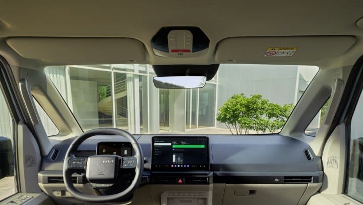 Kia vehicle interior showing the overhead SOS button and dashboard