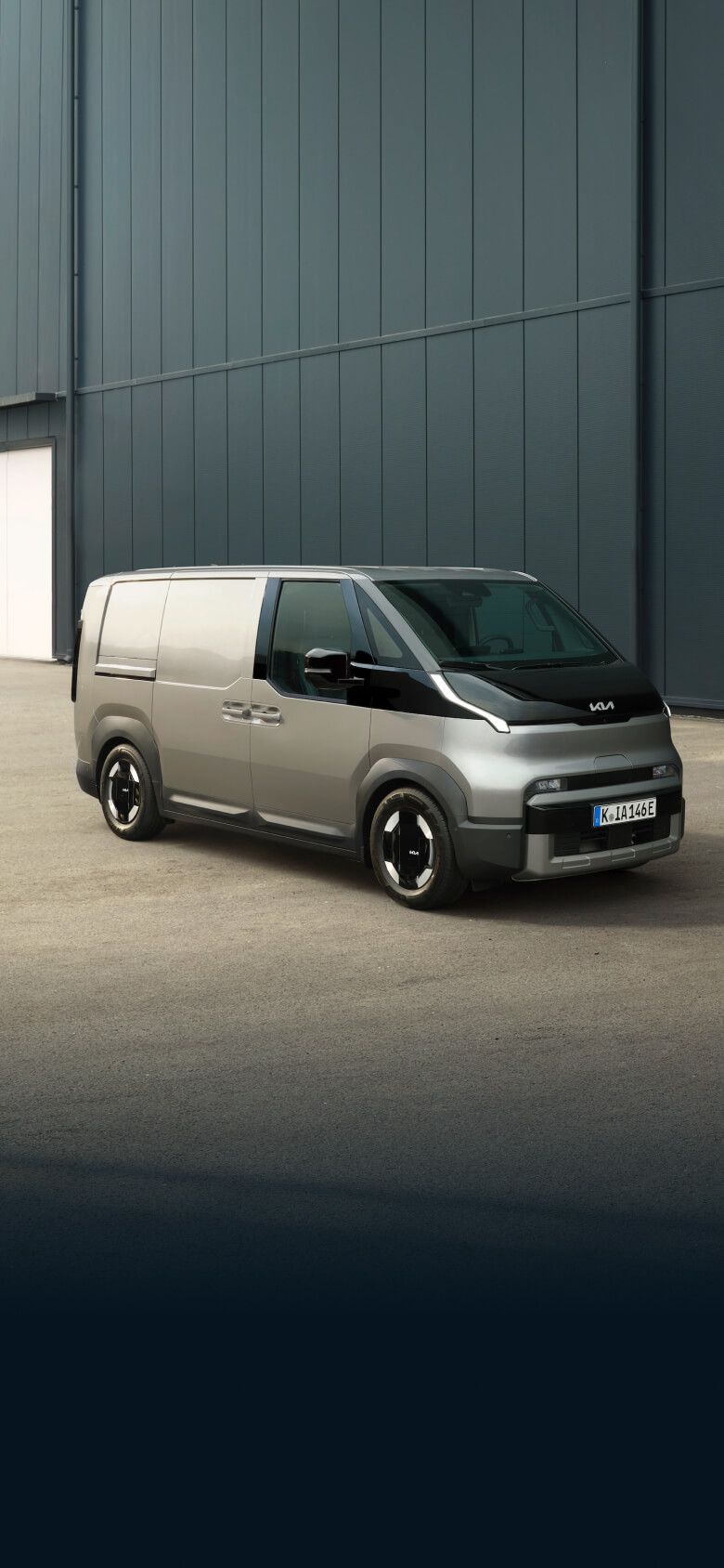 Front-side view of the Kia PV5 Cargo Long parked on an urban street