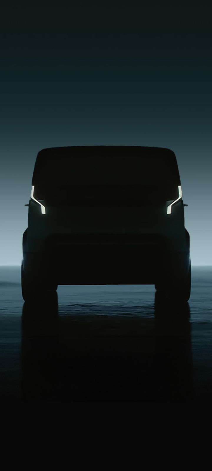 Frontal silhouette view of Kia PBV with illuminated signature lights against dark