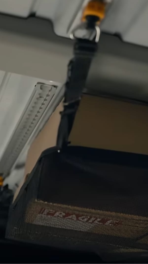 Close-up of a roof L-Track rail mounted on the Kia PV5 Cargo wall