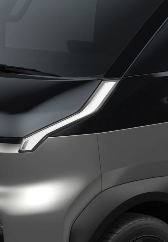 Close-up of the Kia PV5 Cargo front headlight and bonnet design