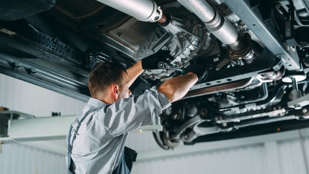 Mechanic working underneath a vehicle