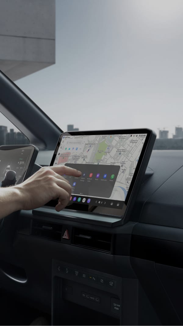 Person interacting with an infotainment touchscreen inside a vehicle