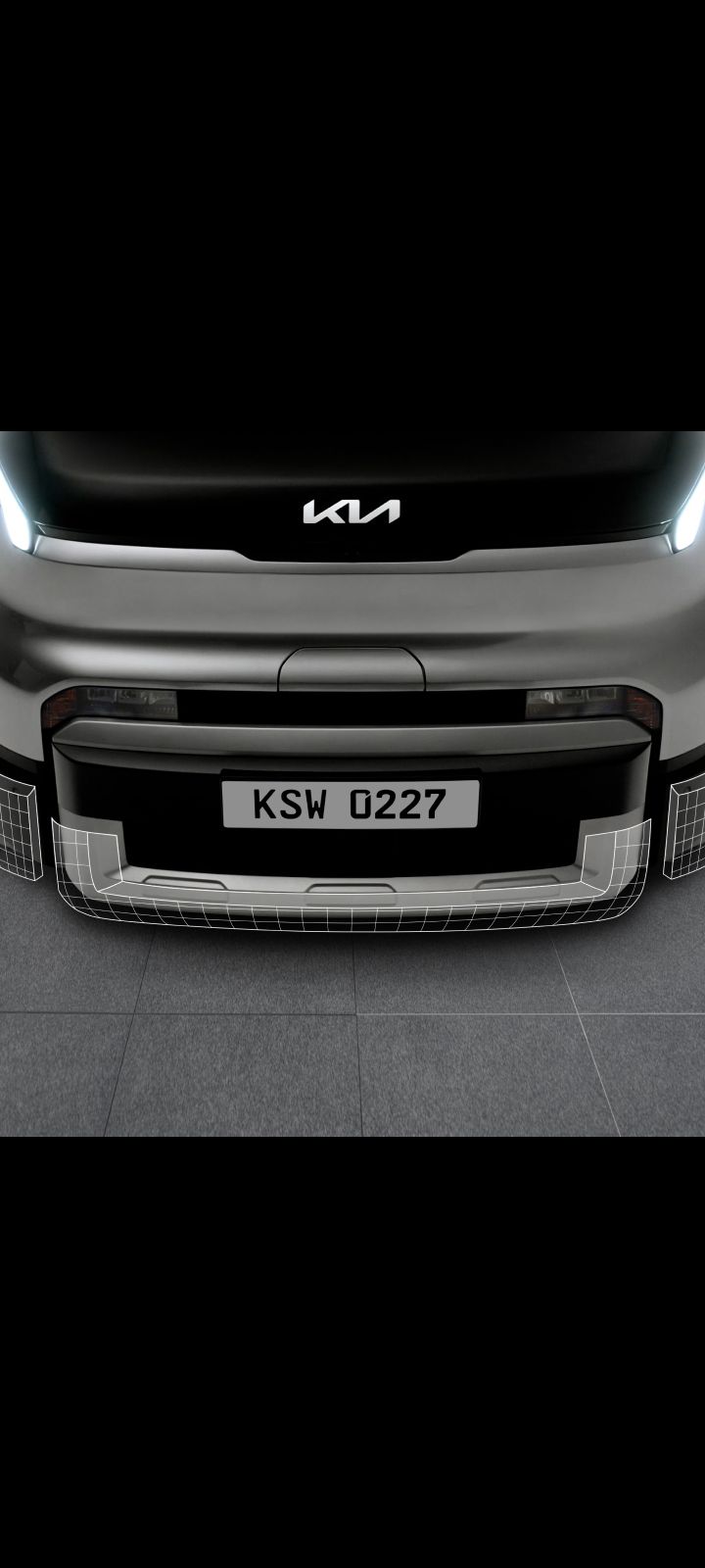 Close-up of the Kia PV5 Cargo front bumper and lower grille
