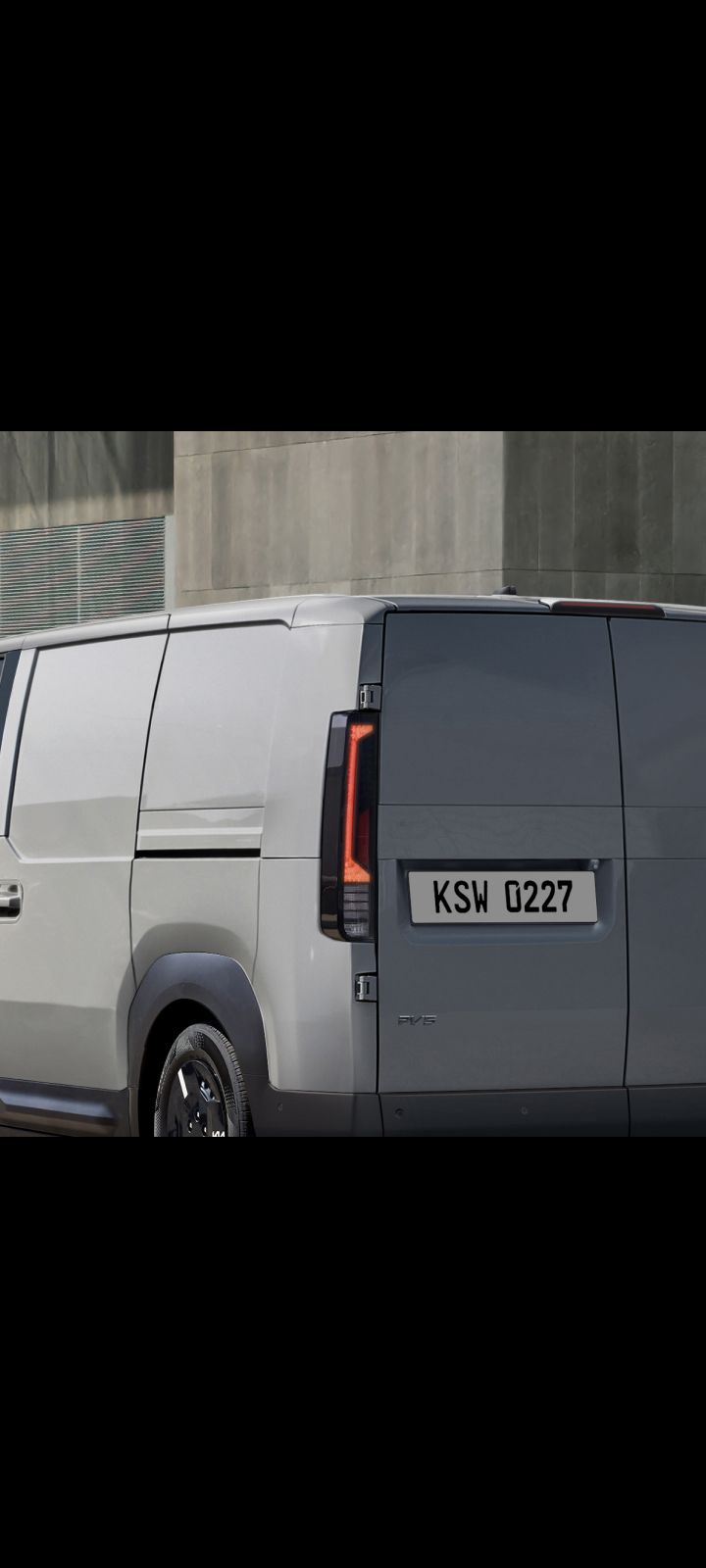 Rear-side view of the Kia PV5 Cargo with rear lamp visible
