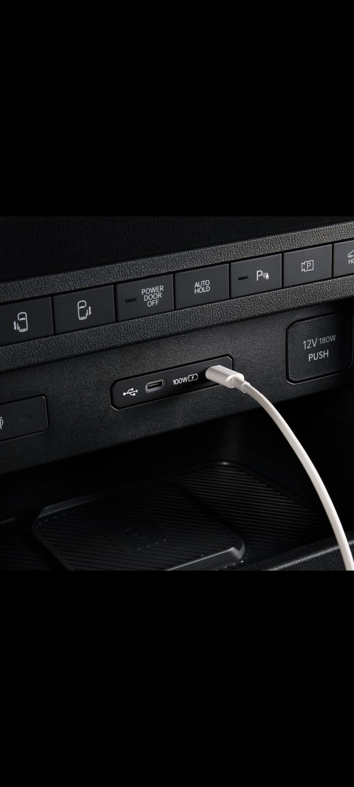 Close-up of the Kia PV5 Cargo dashboard USB port with cable connected
