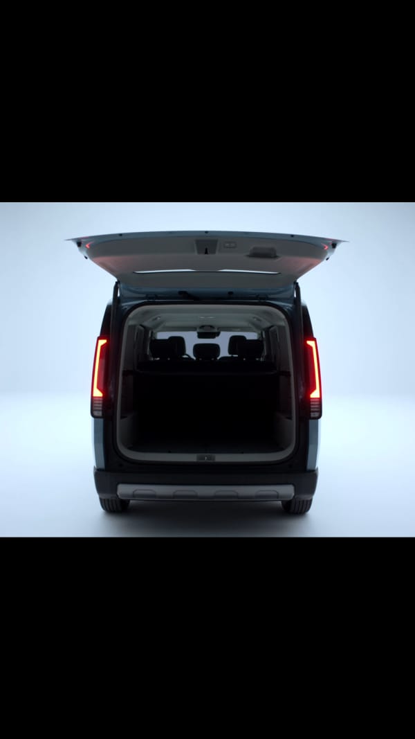 Rear view of the Kia PV5 Passenger with open tailgate revealing cargo space