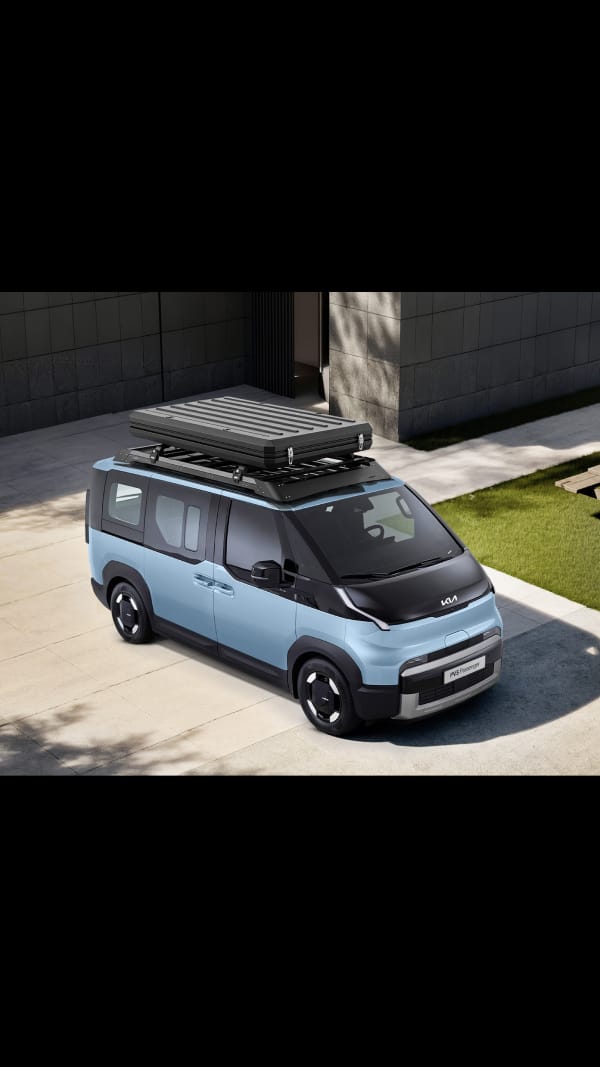 Three-quarter top view of the Kia PV5 Passenger with roof-mounted cargo box