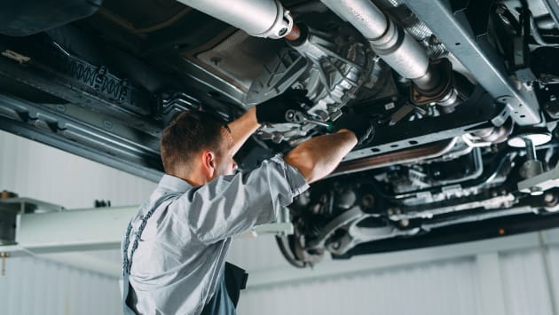 Mechanic working underneath a vehicle