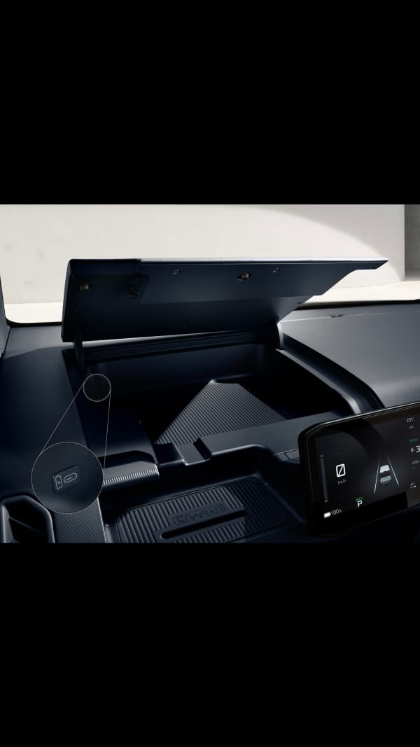 Dashboard storage compartment of the Kia PV5 Passenger being opened