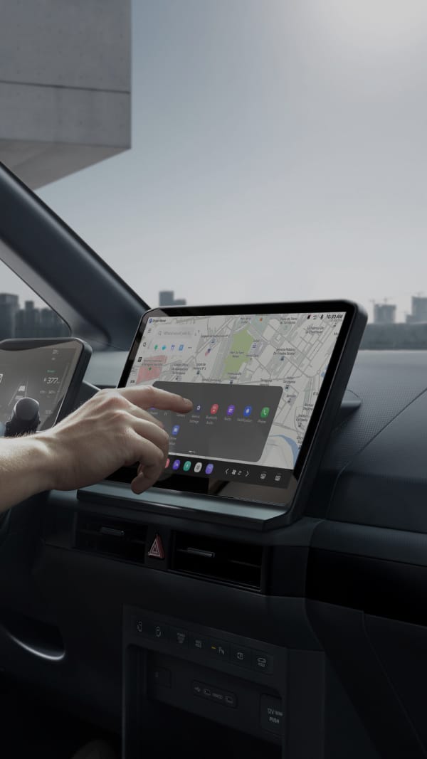 Person interacting with an infotainment touchscreen inside a vehicle