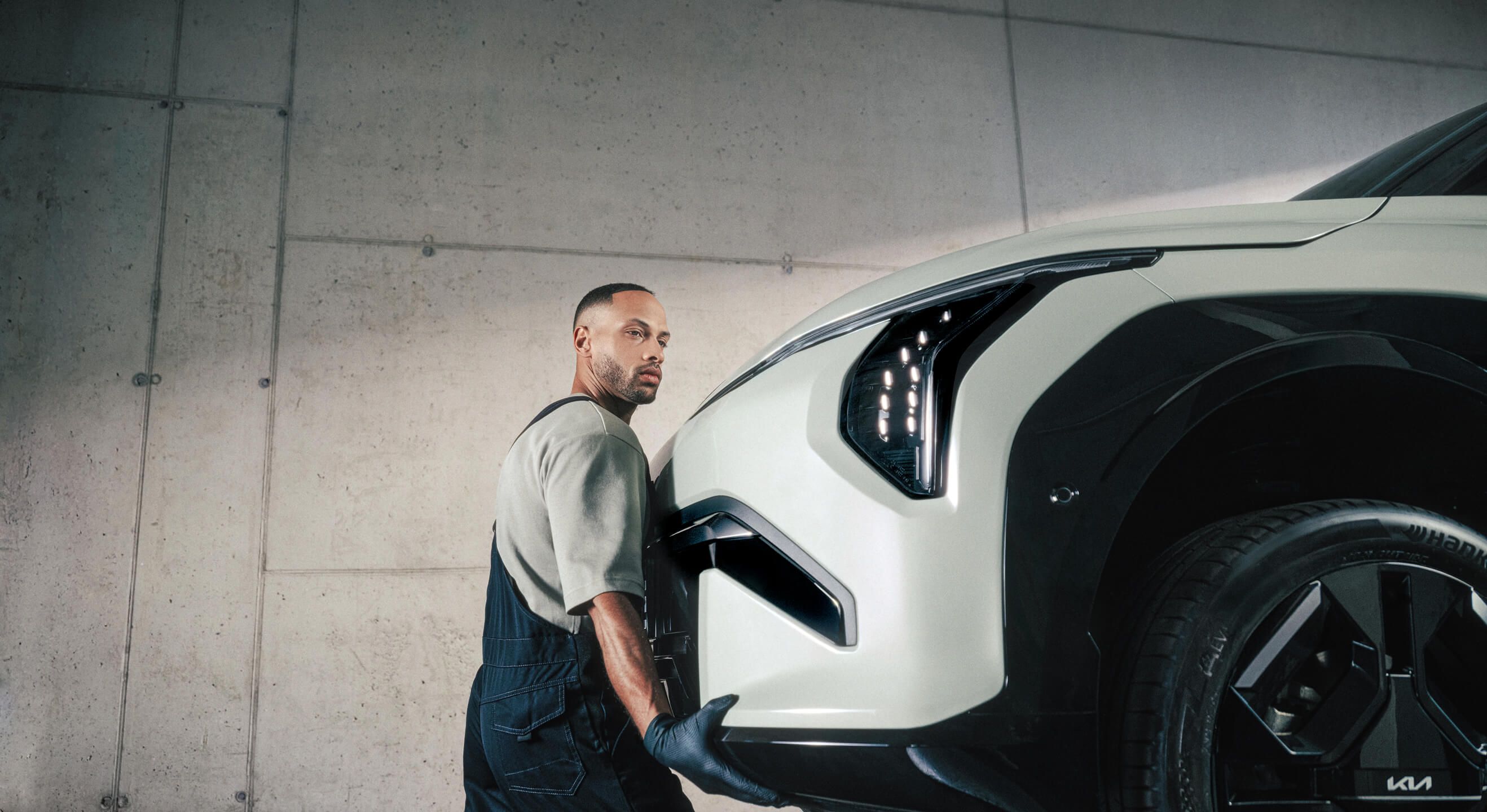 Kia Technician installs a Kia Genuine Front Bumper on a Kia EV3. 