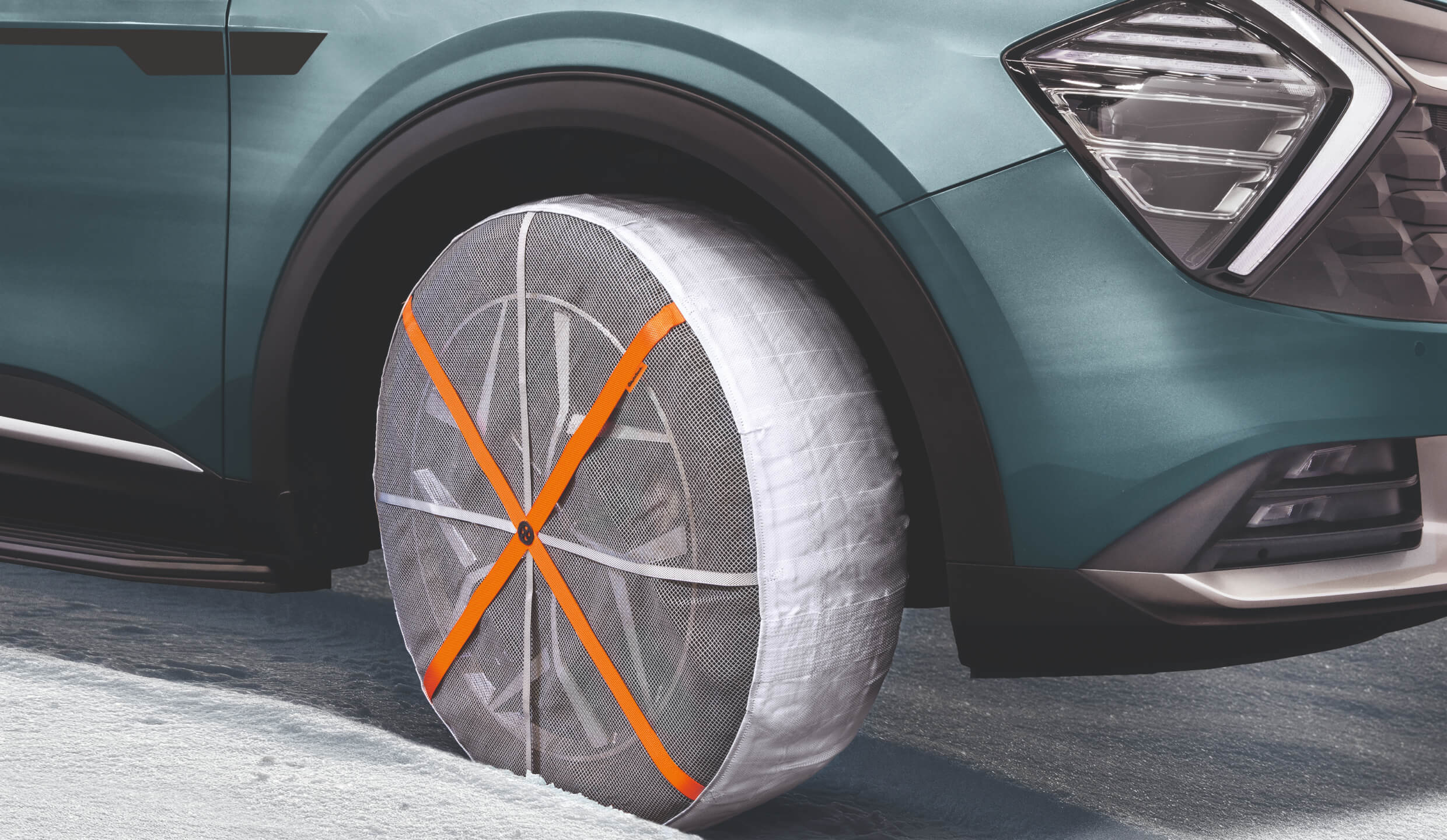 Vehicle drives safely on icy roads with Kia Snow Socks fitted to its tyres.