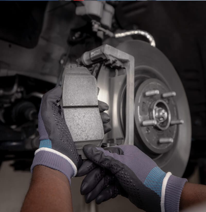 Kia technician installs Kia Genuine Brake Pads and Discs for safe, reliable braking.