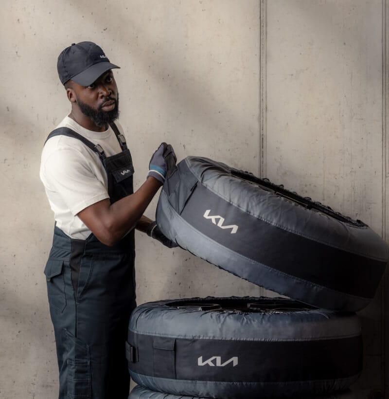 Kia technician removes a set of wrapped tyres from the Kia Tyre Hotel for seasonal storage.