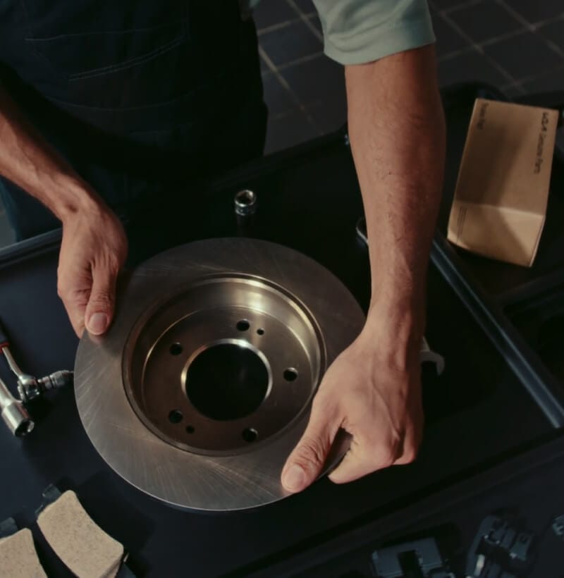 Kia technician prepares Kia Genuine Brake Pads and Discs for installation.