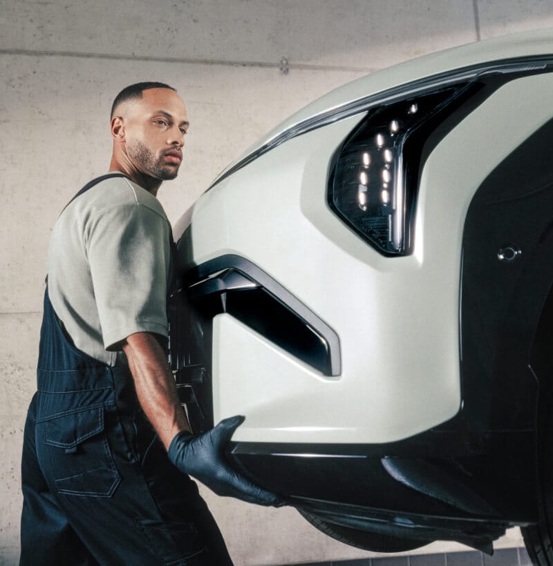 Kia Technician installs a Kia Genuine Front Bumper on a Kia EV3.