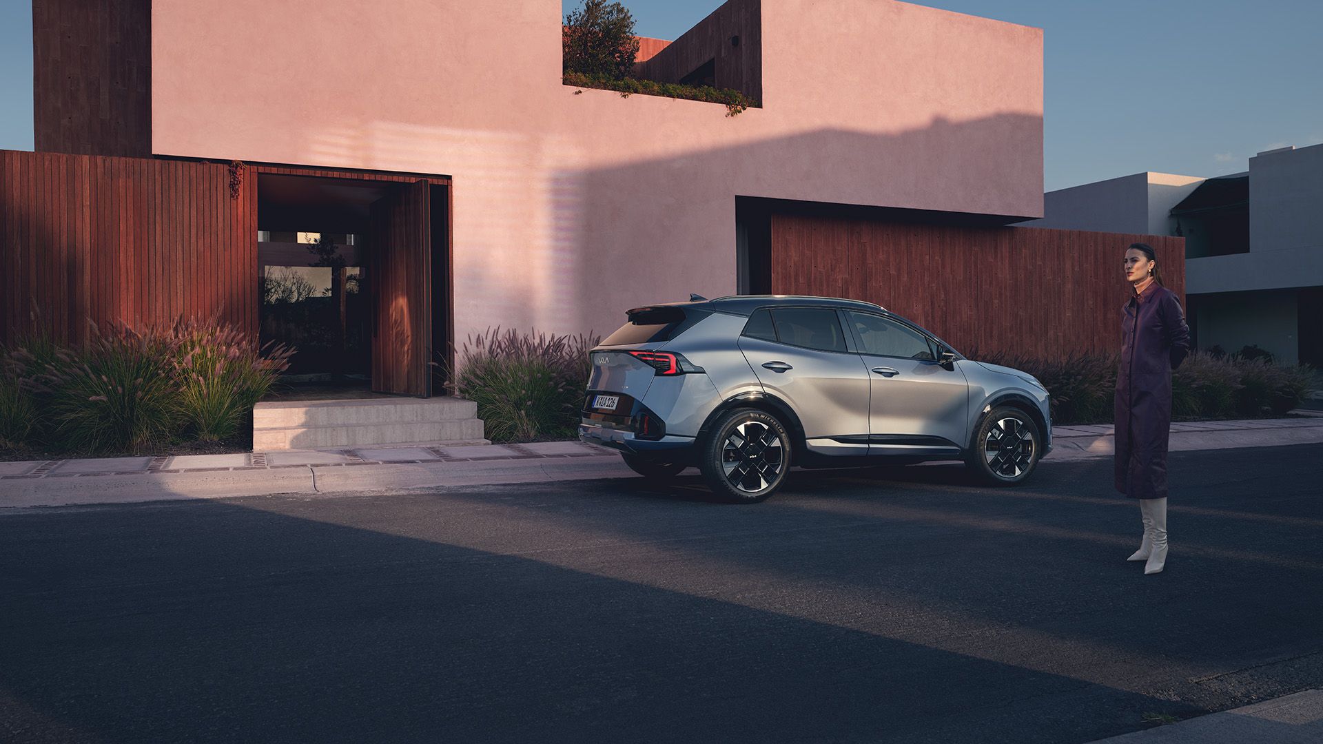 Kia Sportage rear three-quarter view parked outside a modern house